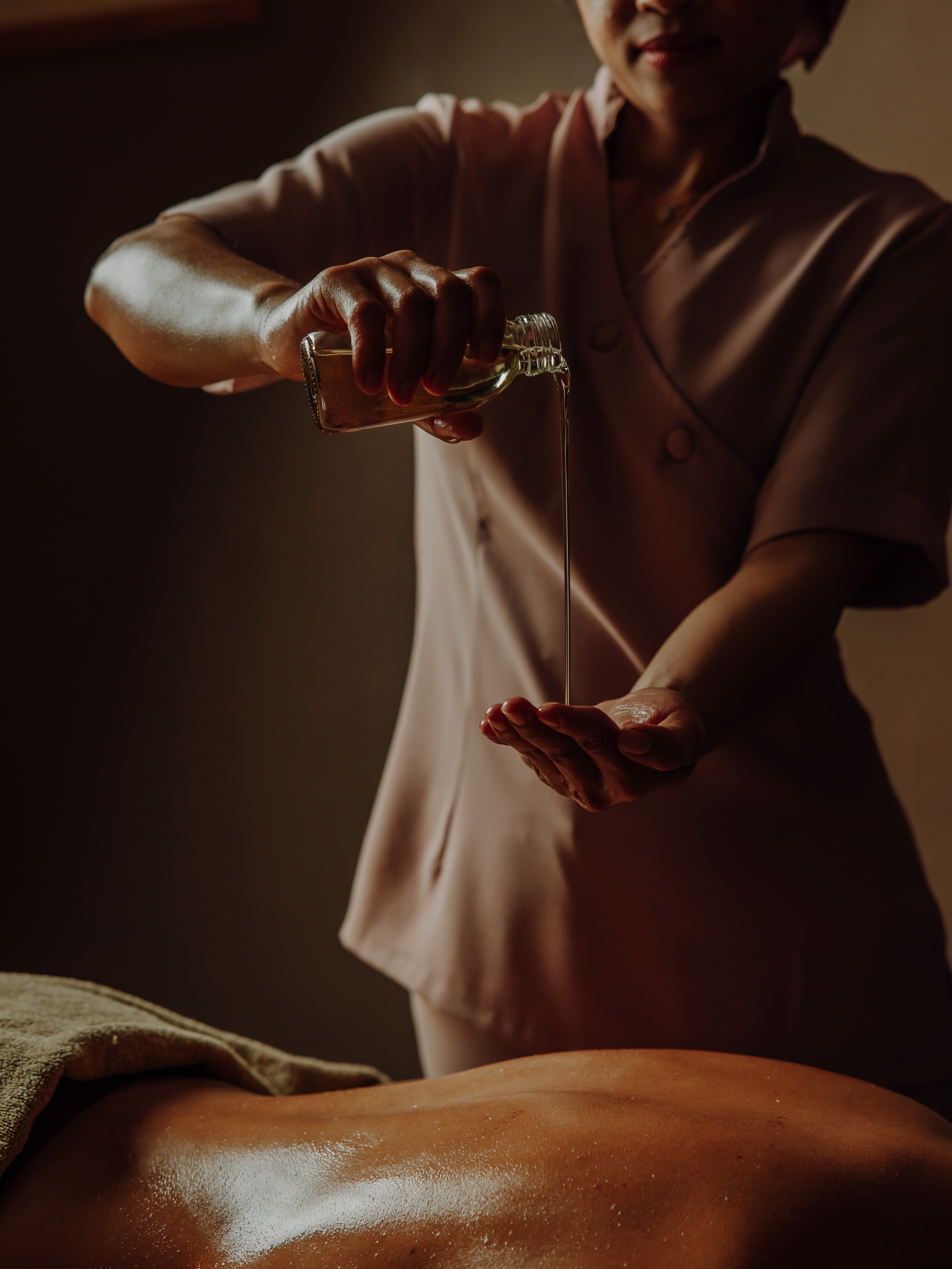 Massage with heated oils on a warmed table