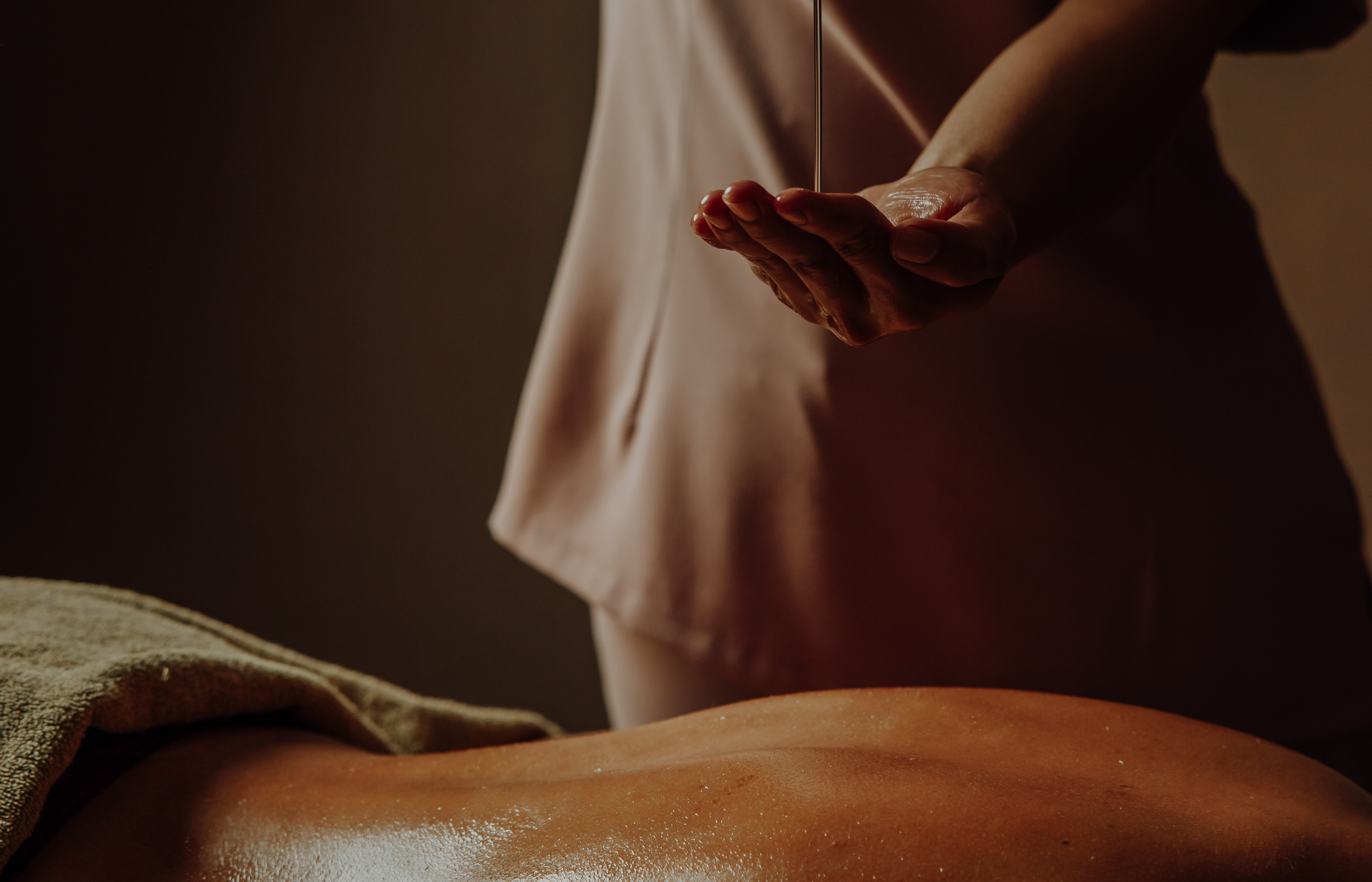 Massage with heated oils on a warmed table